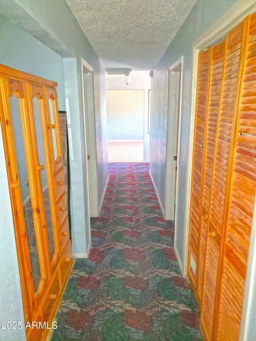 a spacious bedroom with a bed and wooden floor