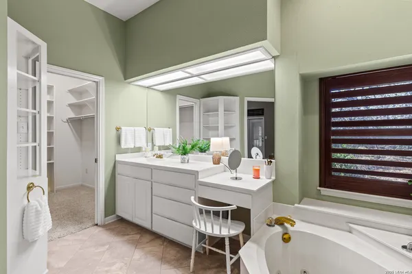 a bathroom with a granite countertop sink mirror and toilet