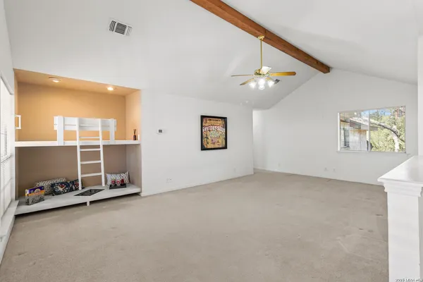 a living room with furniture a flat screen tv and a window