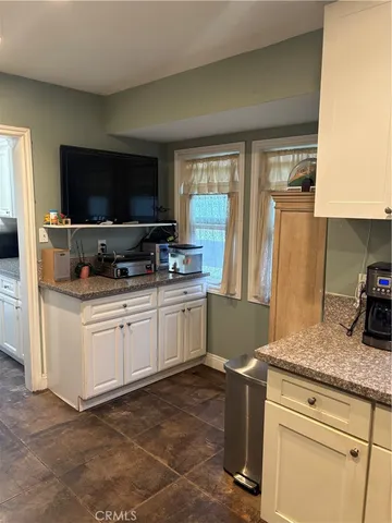 a kitchen with a refrigerator and a stove top oven