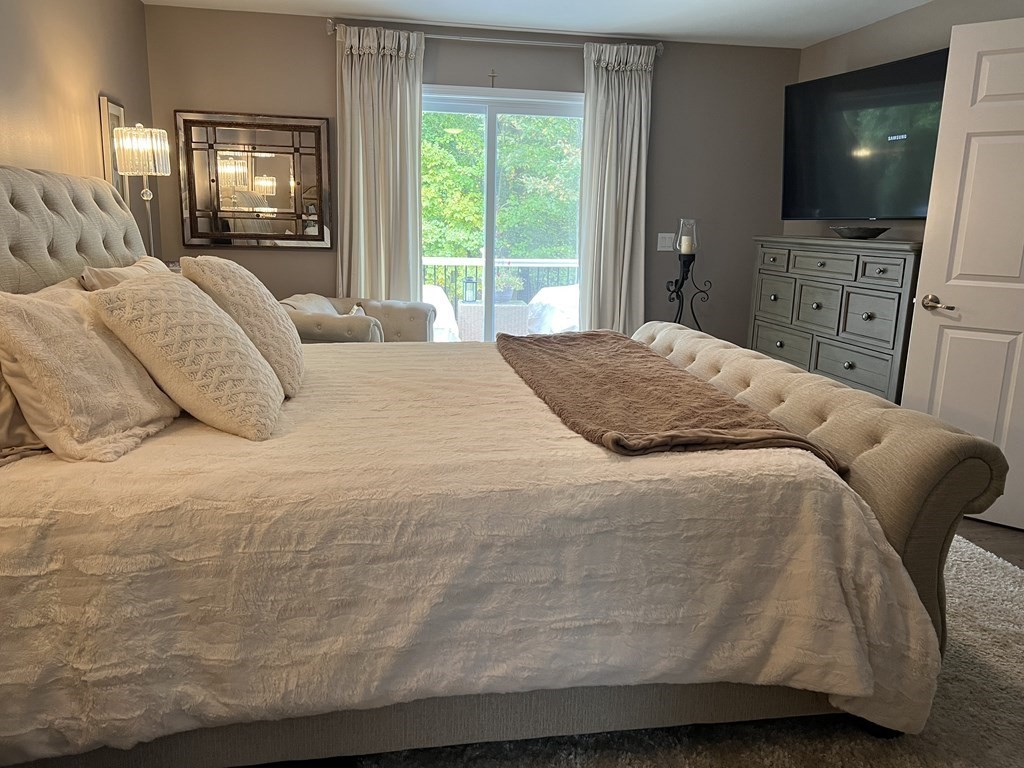 171 Forest Street Middleton, MA 01949 - Photo 12 of 35 a bedroom with a bed and a flat screen tv