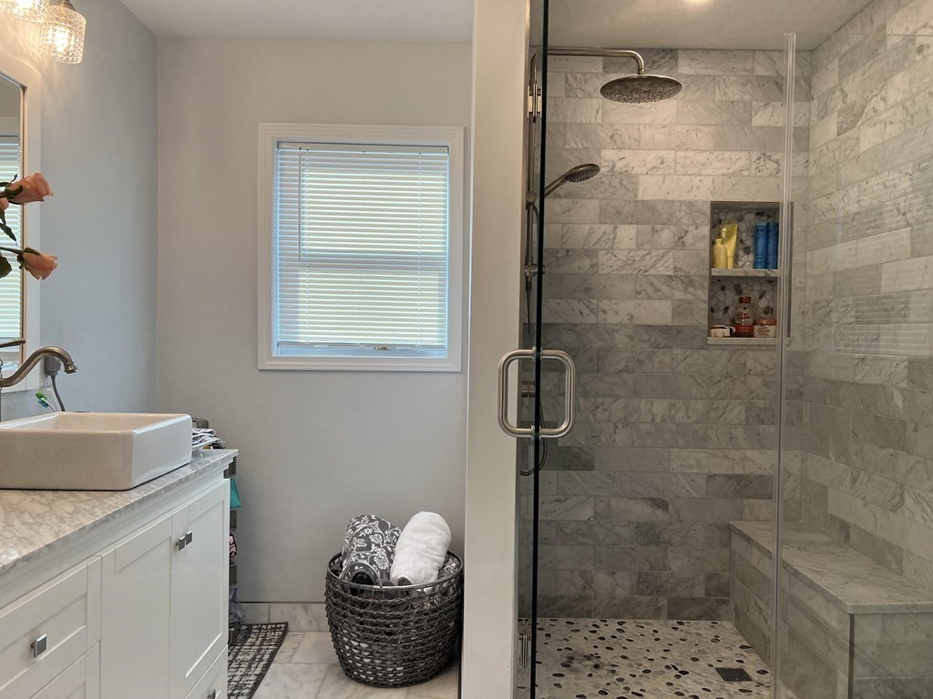 171 Forest Street Middleton, MA 01949 - Photo 15 of 35 a bathroom with a granite countertop shower a sink and a toilet