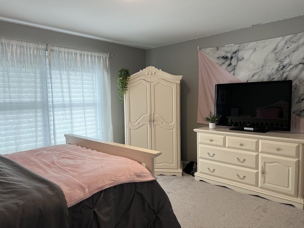 171 Forest Street Middleton, MA 01949 - Photo 20 of 35 a bedroom with a bed television and window