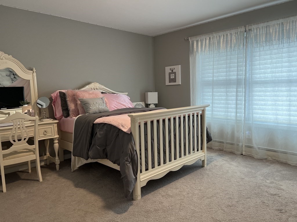 171 Forest Street Middleton, MA 01949 - Photo 21 of 35 a bedroom with a bed and a tv