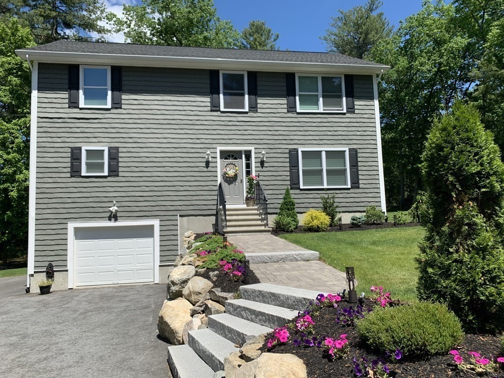 171 Forest Street Middleton, MA 01949 - Photo 3 of 35 a view of a house with a yard and a garden