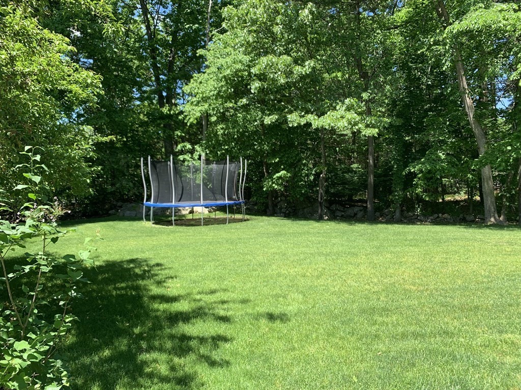 171 Forest Street Middleton, MA 01949 - Photo 4 of 35 a view of a backyard with a garden