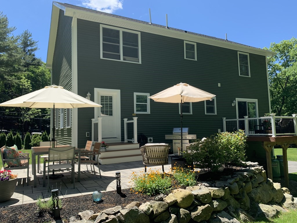 171 Forest Street Middleton, MA 01949 - Photo 5 of 35 a backyard of a house with yard fire pit and outdoor seating