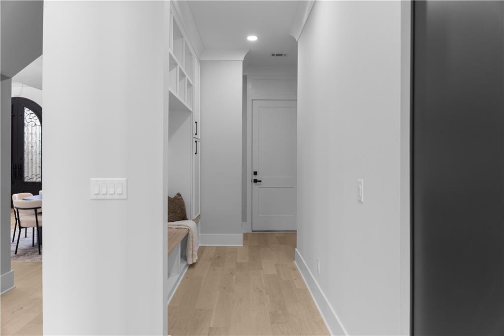 405 Thunder Road Buford, GA 30518 - Photo 46 of 104 a view of a hallway with wooden floor and a bathroom
