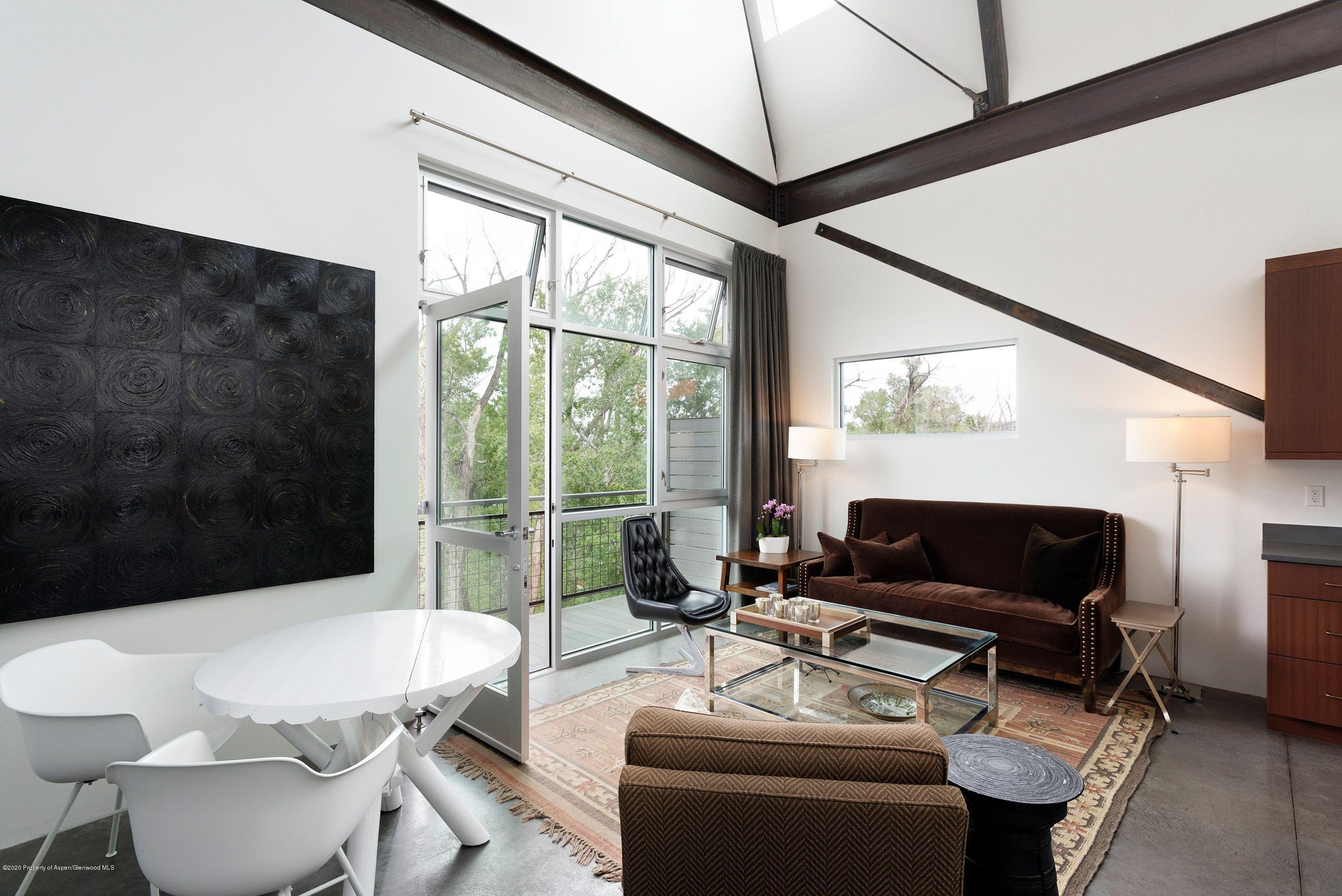 35 Widget Street, Unit 516 Basalt, CO 81621 - Photo 11 of 14 a living room with furniture a flat screen tv and a floor to ceiling window