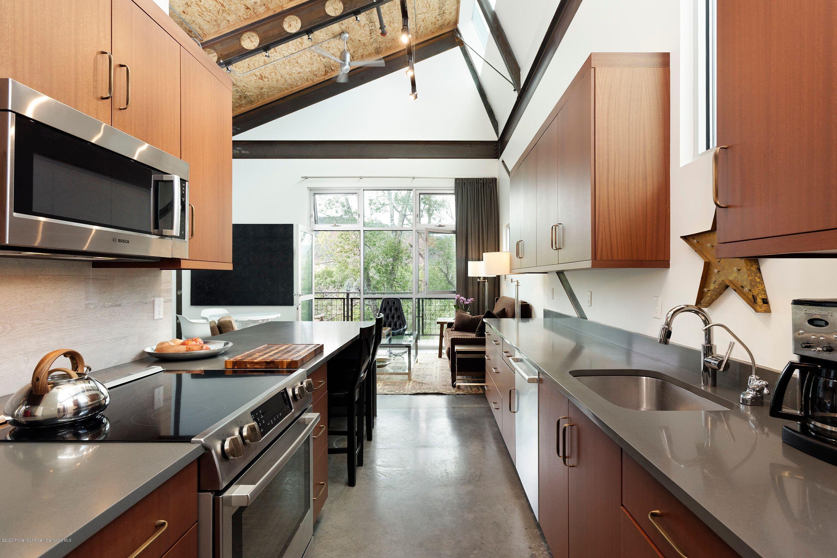 35 Widget Street, Unit 516 Basalt, CO 81621 - Photo 5 of 14 a kitchen with stainless steel appliances a sink stove and microwave