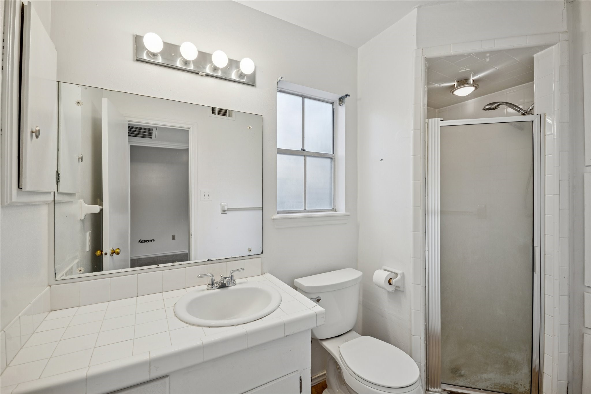 13603 Boca Raton Drive Houston, TX 77069 - Photo 25 of 27 a bathroom with a granite countertop sink toilet a mirror and shower