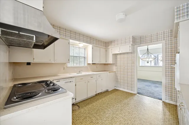 a kitchen with a sink stove and cabinets