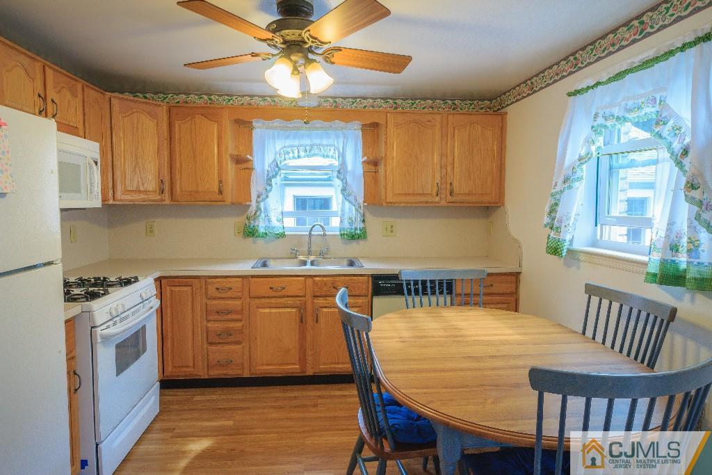 129 Middlesex Avenue Iselin, NJ 08830 - Photo 11 of 23 a kitchen with stainless steel appliances granite countertop a stove a sink a microwave cabinets and a dining table