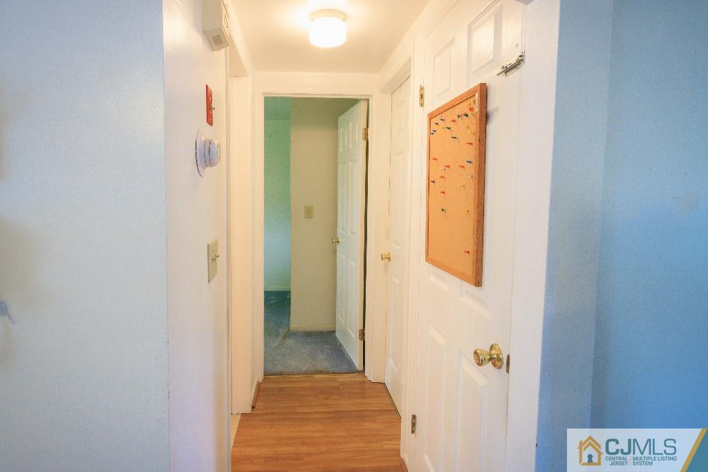 129 Middlesex Avenue Iselin, NJ 08830 - Photo 13 of 23 a view of a hallway with wooden floor and closet