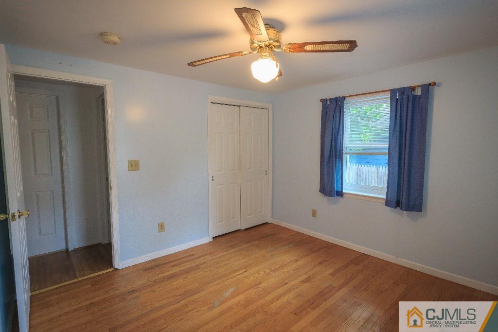 129 Middlesex Avenue Iselin, NJ 08830 - Photo 15 of 23 wooden floor in an empty room with a window