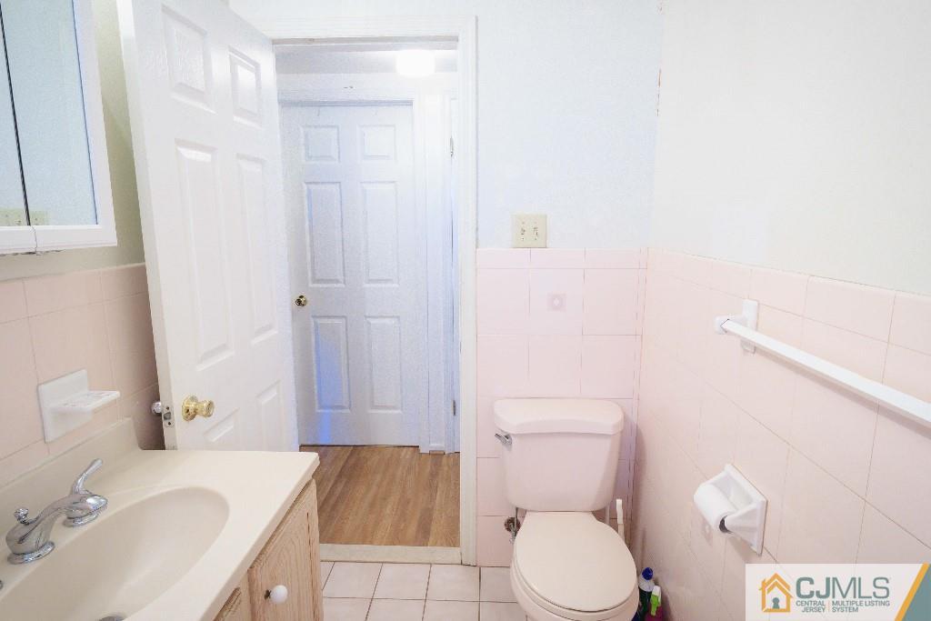 129 Middlesex Avenue Iselin, NJ 08830 - Photo 17 of 23 a bathroom with a granite countertop sink toilet and shower