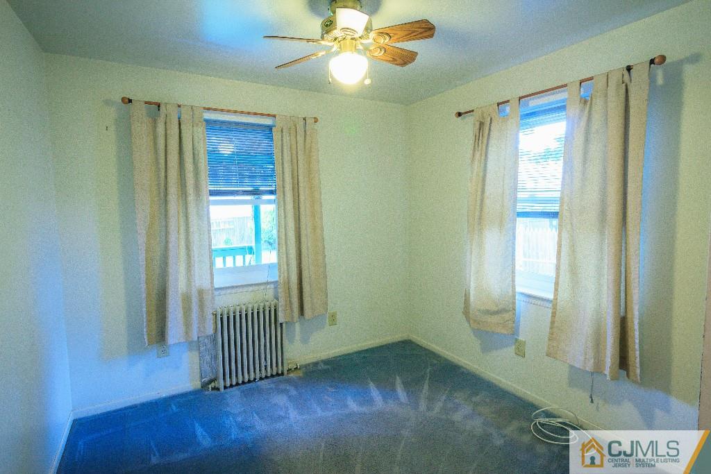 129 Middlesex Avenue Iselin, NJ 08830 - Photo 18 of 23 wooden floor in an empty room with a window