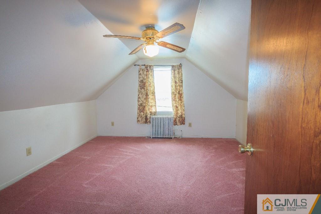 129 Middlesex Avenue Iselin, NJ 08830 - Photo 19 of 23 an empty room with a window and a ceiling fan