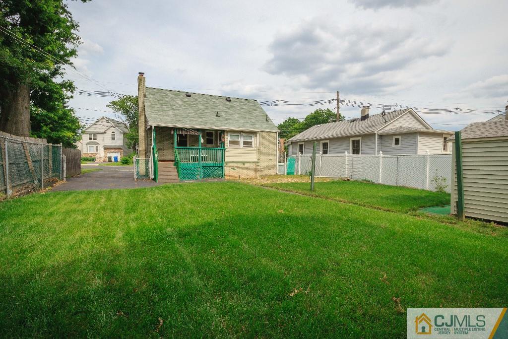 129 Middlesex Avenue Iselin, NJ 08830 - Photo 3 of 23 a front view of a house with a garden and yard