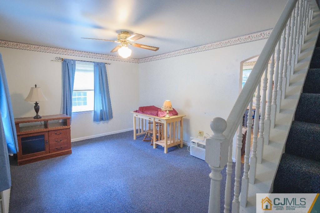 129 Middlesex Avenue Iselin, NJ 08830 - Photo 8 of 23 a livingroom with furniture and a ceiling fan