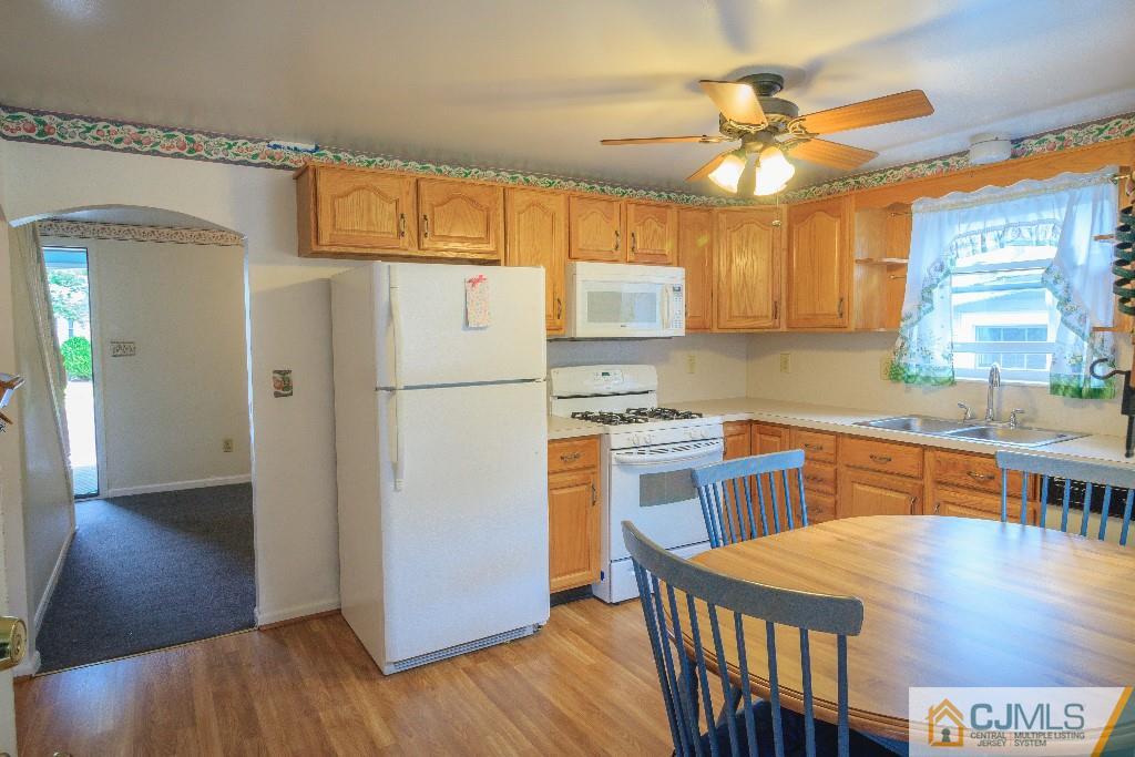 129 Middlesex Avenue Iselin, NJ 08830 - Photo 10 of 23 a kitchen with stainless steel appliances granite countertop a refrigerator a sink dishwasher and a stove with wooden floor