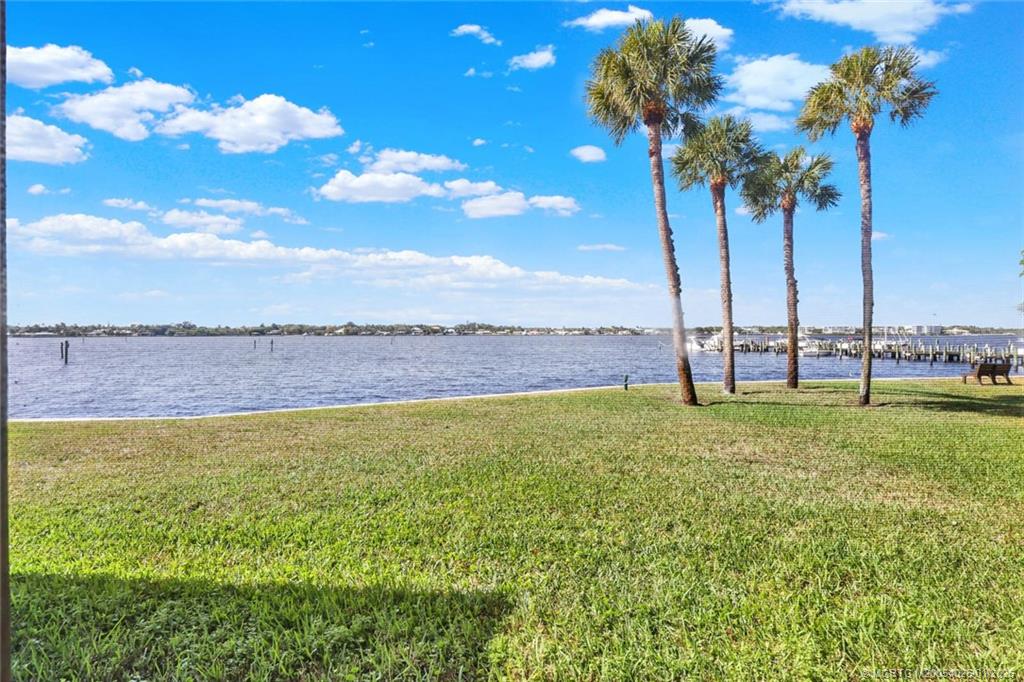 1950 Southwest Palm City Road, Unit 8106 Stuart, FL 34994 - Photo 21 of 54 a view of a yard with a lake