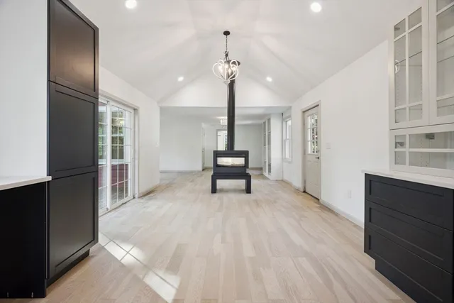 a view of empty room with wooden floor and windows