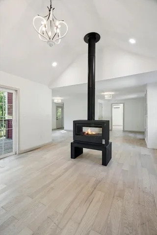 a view of an empty room with a chandelier