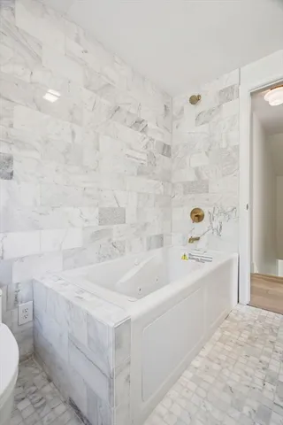 a bathroom with a bathtub and a sink
