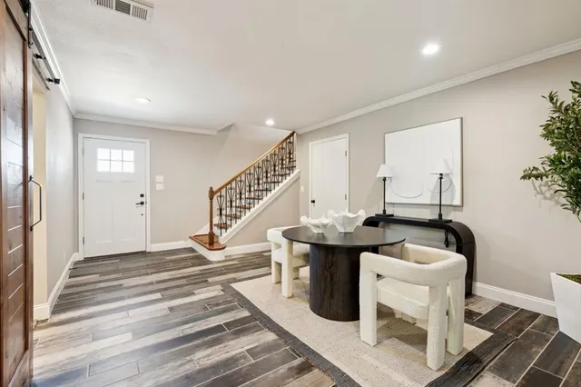 a bathroom with a sink mirror and toilet