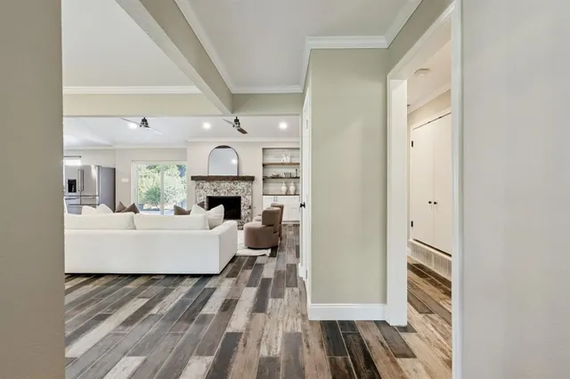 a living room with fireplace furniture and a wooden floor