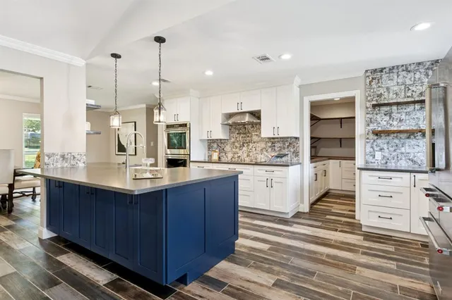 a kitchen with stainless steel appliances granite countertop a sink stove and cabinets