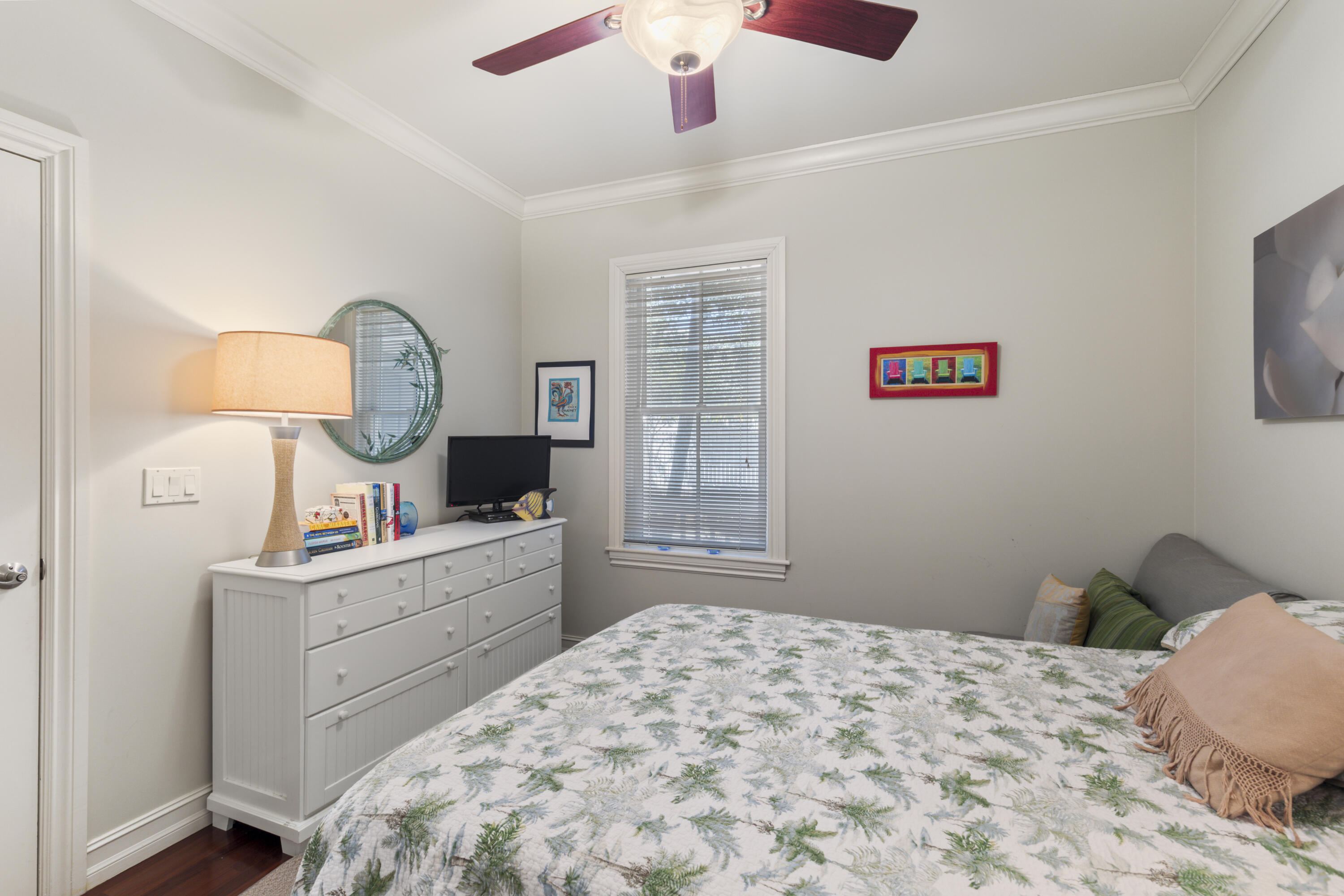 120 Angela Street, Unit 102 Key West, FL 33040 - Photo 15 of 24 a bedroom with a bed and a chandelier