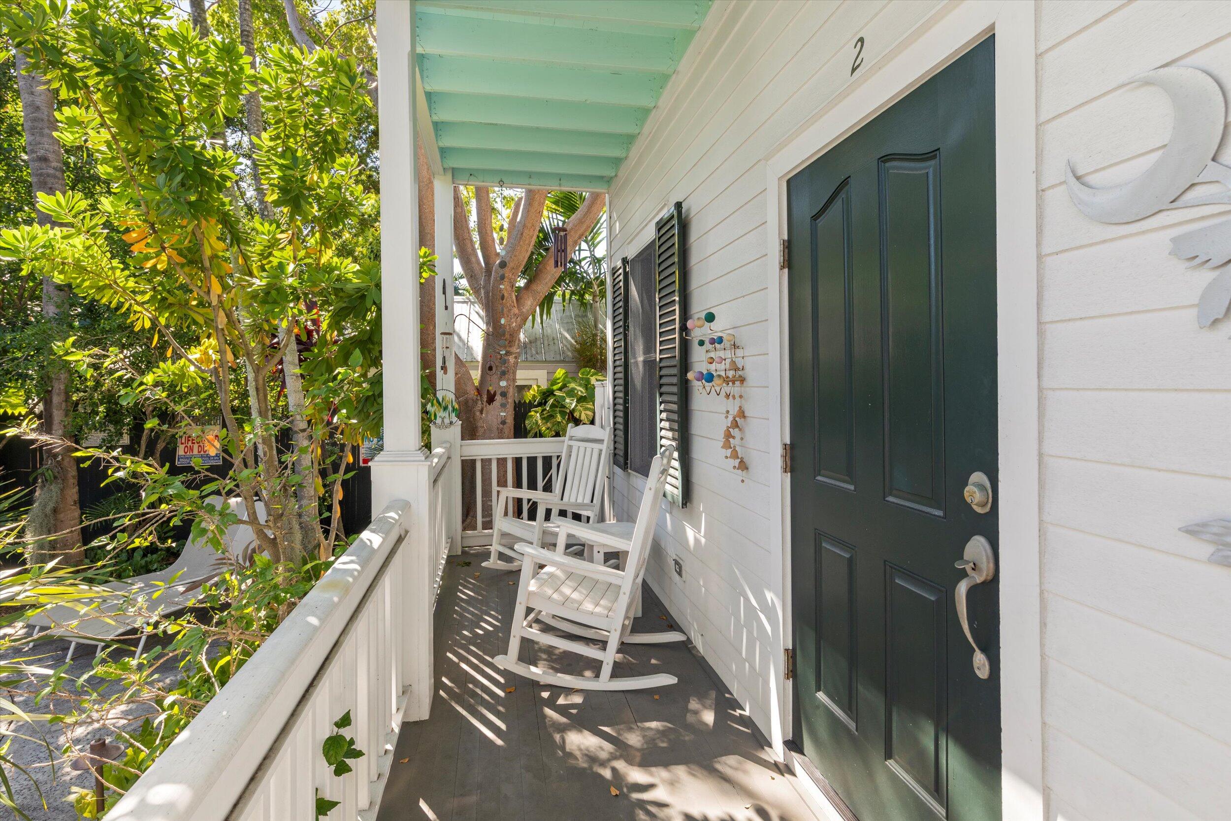 120 Angela Street, Unit 102 Key West, FL 33040 - Photo 3 of 24 a balcony with wooden floor and outdoor space