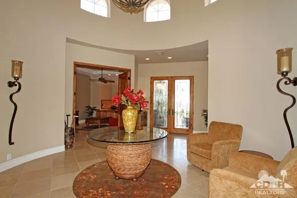 a living room with furniture and large windows