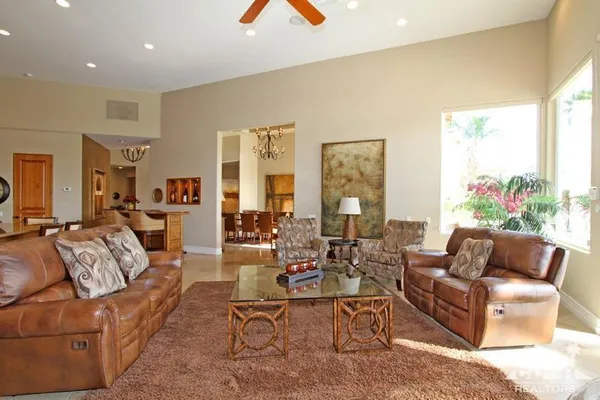 a dining room with stainless steel appliances a dining table chairs and kitchen view