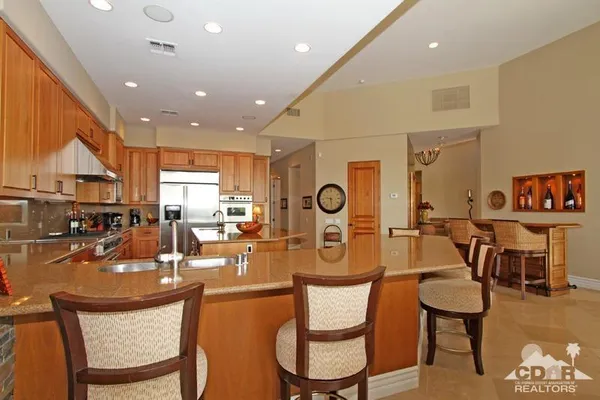 a dining room with wooden floor and a chandelier
