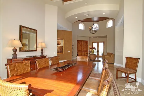 a spacious bedroom with a bed and a flat screen tv