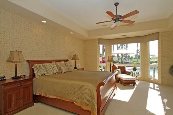 a bedroom with furniture and a flat screen tv