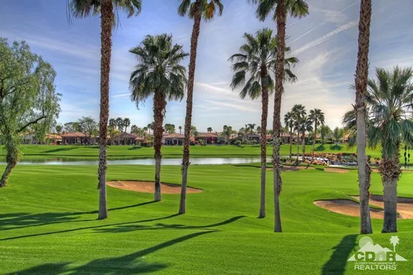 a view of a house with patio and a yard