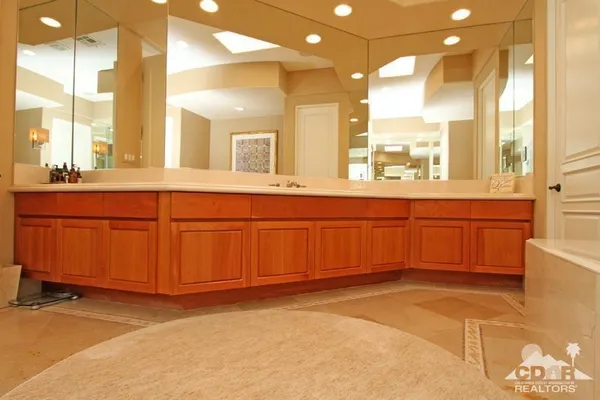 a bathroom with a double vanity sink a mirror and a shower