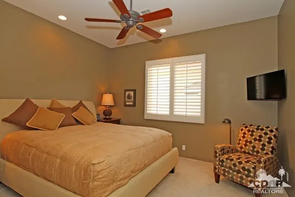 a view of a patio with furniture and umbrella