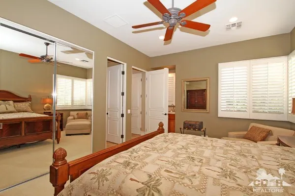 a front view of a house with a yard and potted plants
