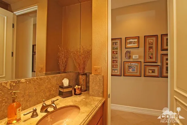 a view of a patio with a table and chairs under an umbrella