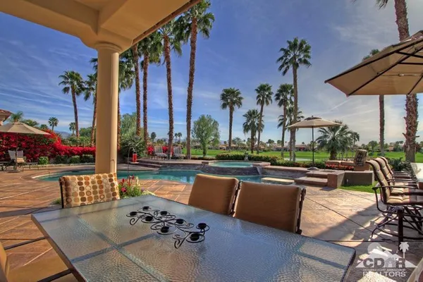 a view of swimming pool having outdoor seating