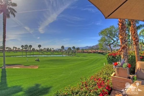 a front view of a house with a yard and a garage