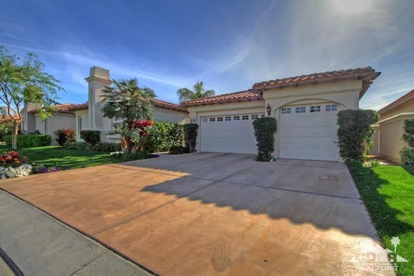 a dining room with furniture and a potted plant