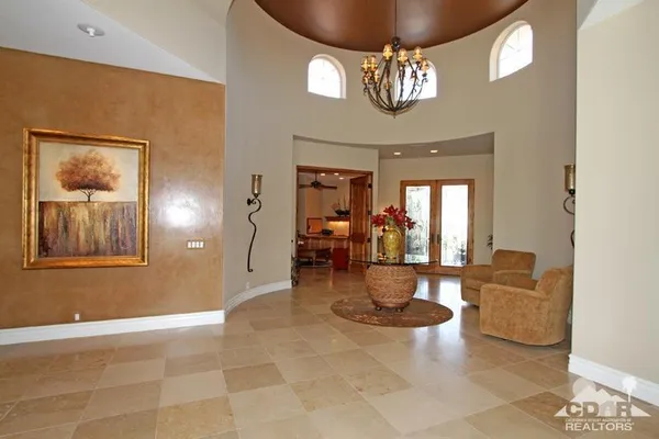 a living room with furniture and a floor to ceiling window