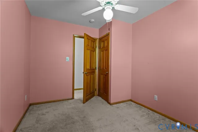 a backyard of a house with trees and wooden fence