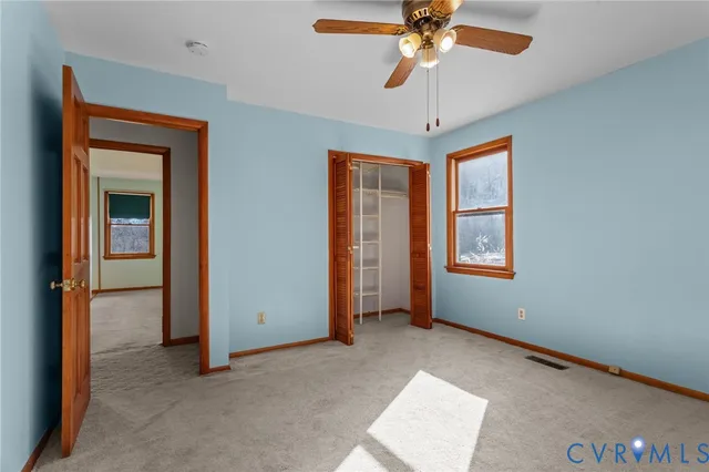 a view of a house with a wooden deck and furniture